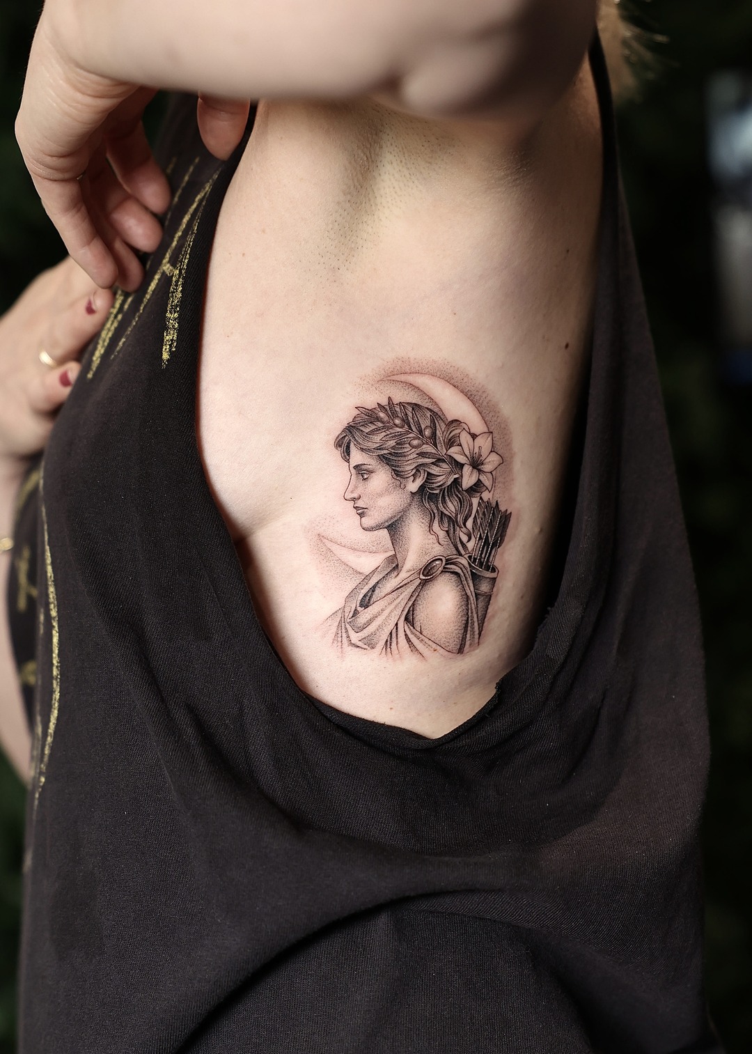 Artemis goddess with arrows ribs tattoo, black and grey by Matt Roe, Kensington London