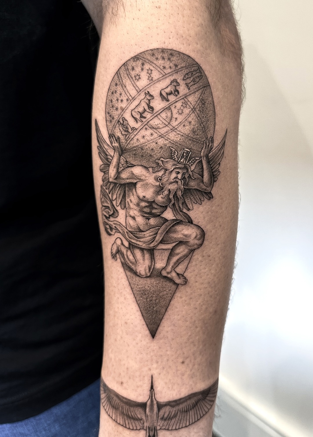 Atlas holding celestial sphere tattoo on forearm, black and grey by Matt Roe, Kensington London