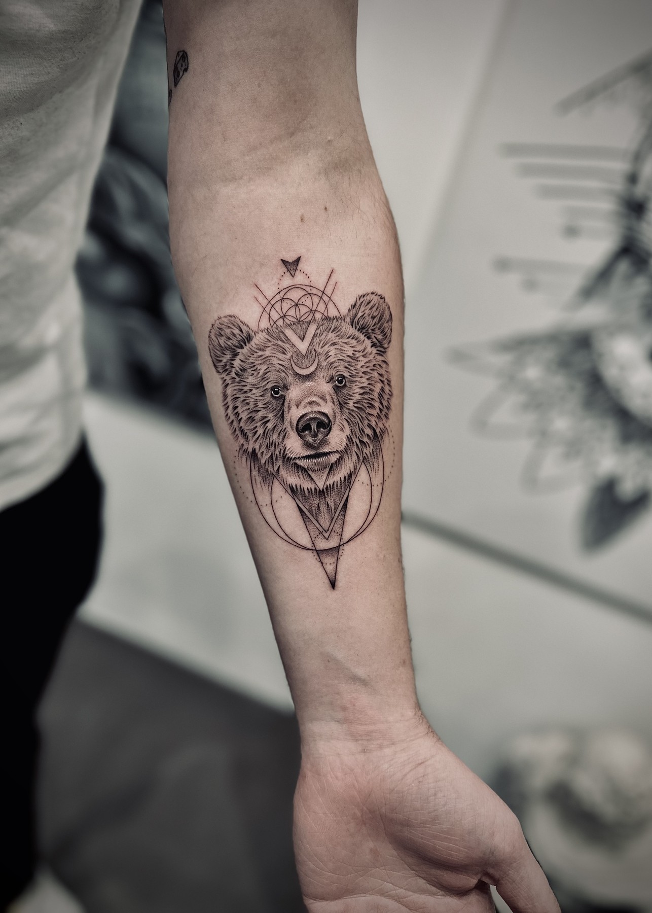 Geometric bear forearm tattoo, black and grey by Matt Roe, Kensington London