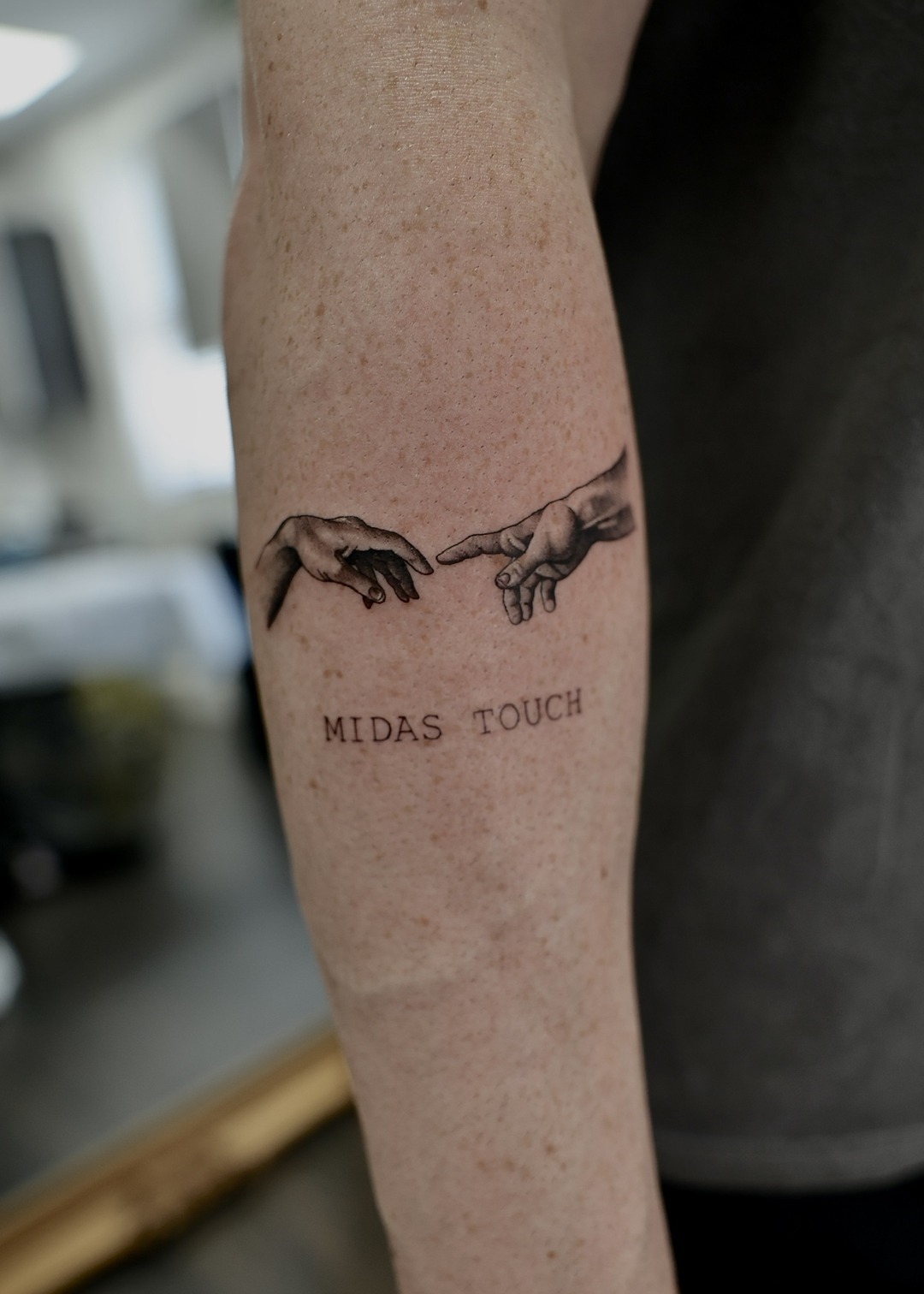 Creation of Adam hands Midas Touch forearm tattoo, black and grey by Matt Roe, Kensington London