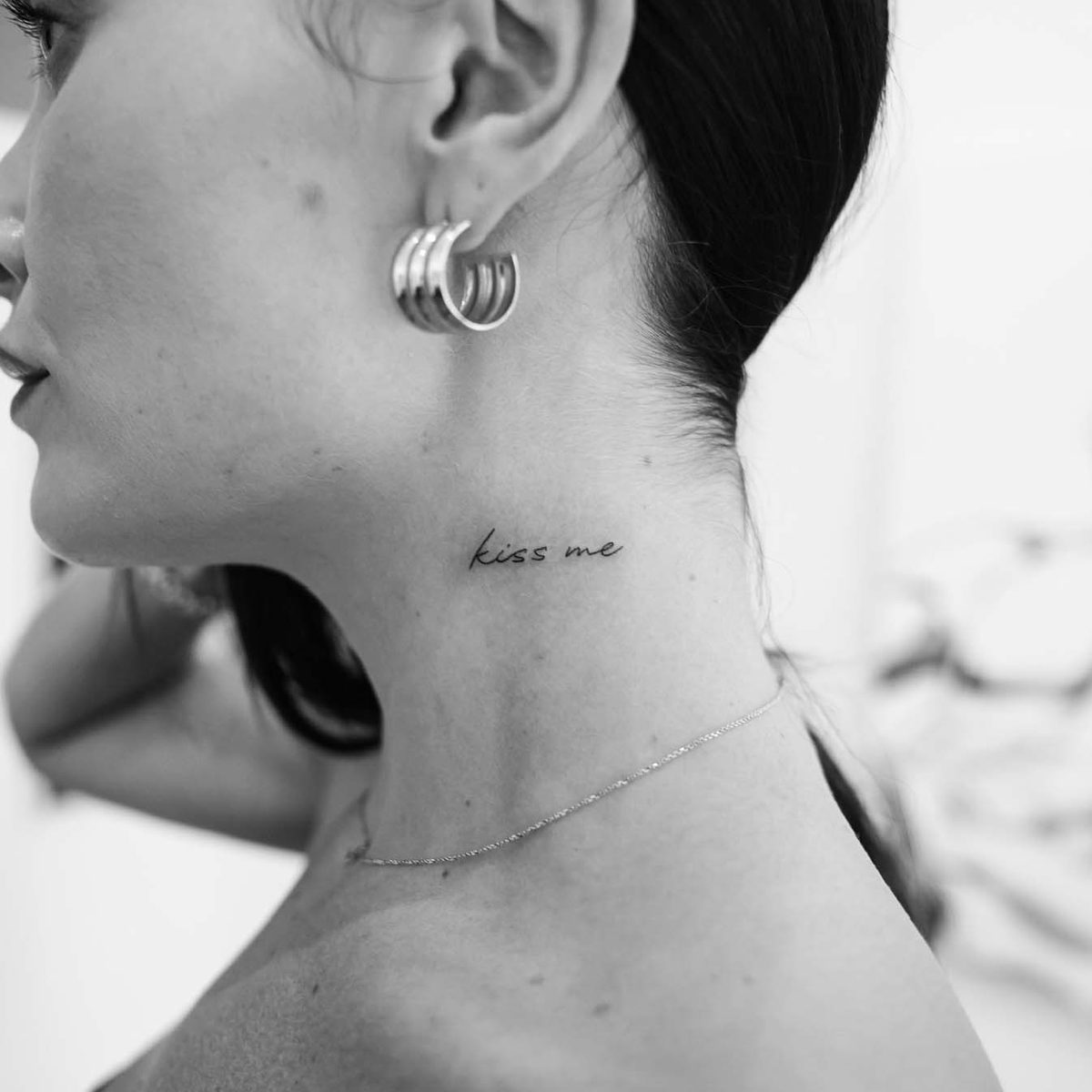Delicate fine line script tattoo on neck by Matt Roe, Kensington London