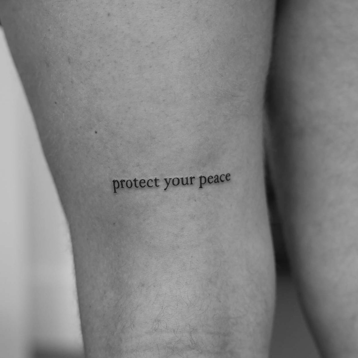 Fine line quote text tattoo on thigh by Matt Roe, London