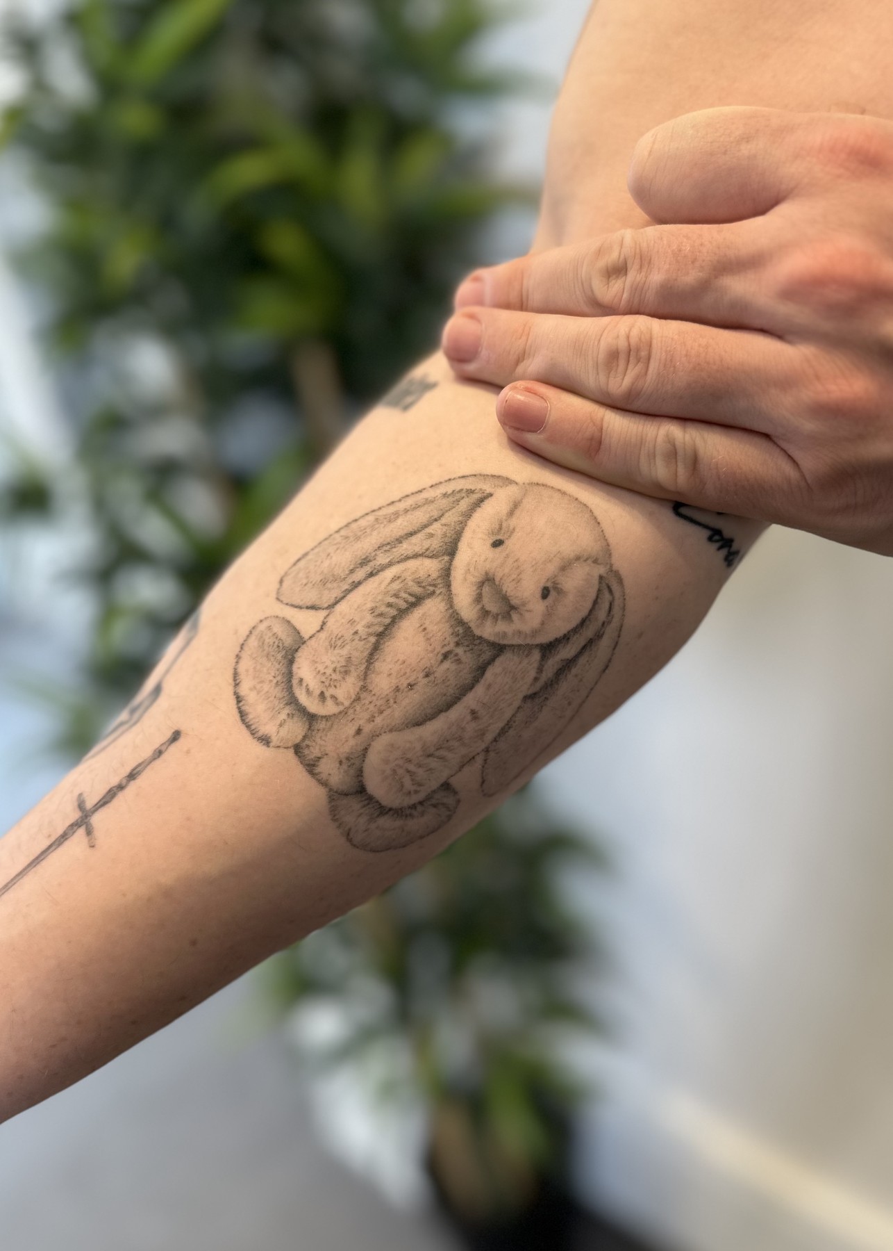 Healed bunny soft toy arm tattoo, black and grey by Matt Roe, Kensington London