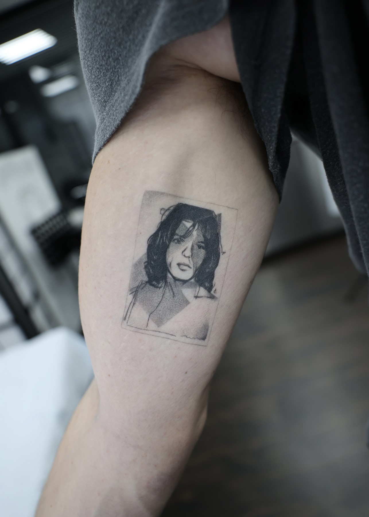 Healed polaroid-style portrait thigh tattoo, black and grey by Matt Roe, Kensington London