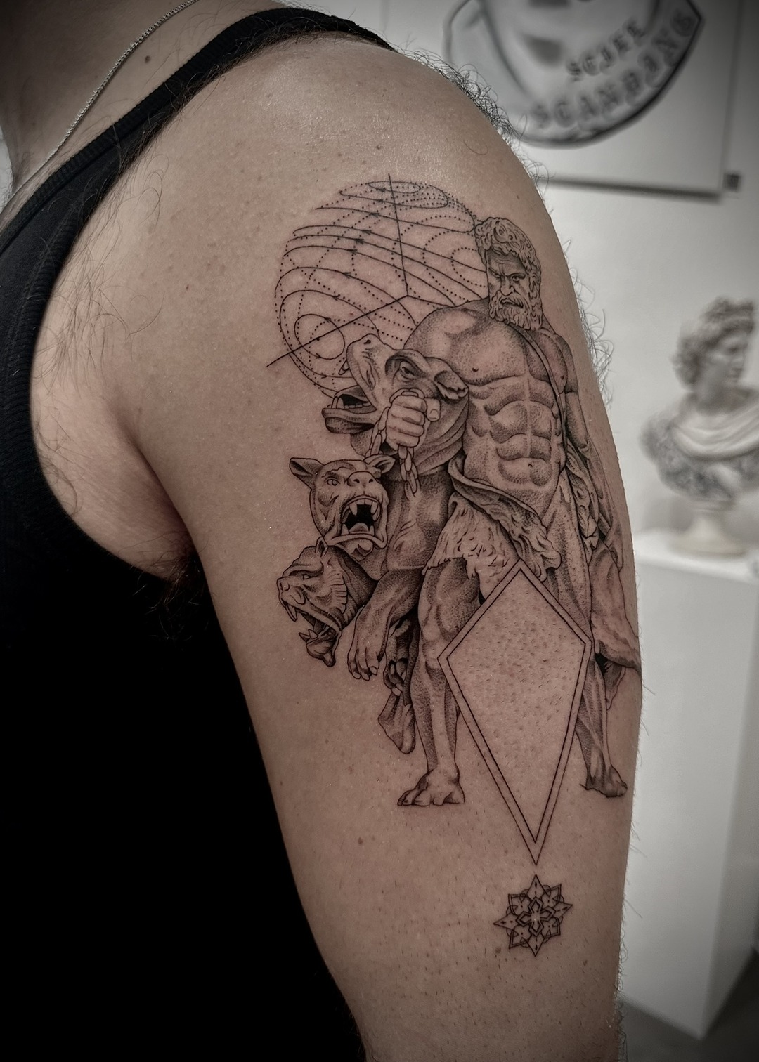 Hercules with Cerberus and celestial sphere shoulder tattoo, black and grey by Matt Roe, Kensington London