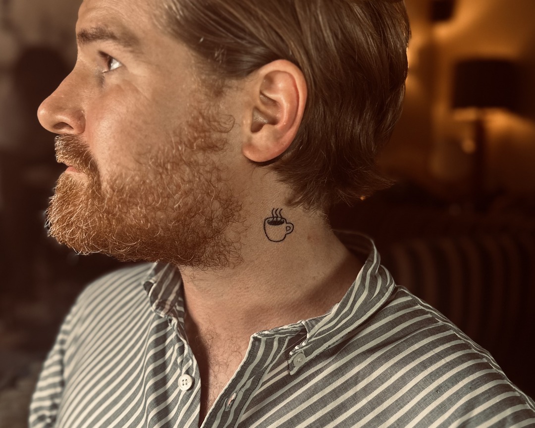 Small coffee cup neck tattoo by Matt Roe