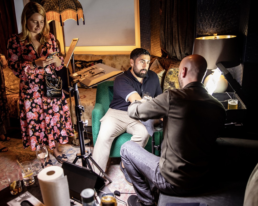 Guests watching Matt Roe tattoo in a private members' lounge