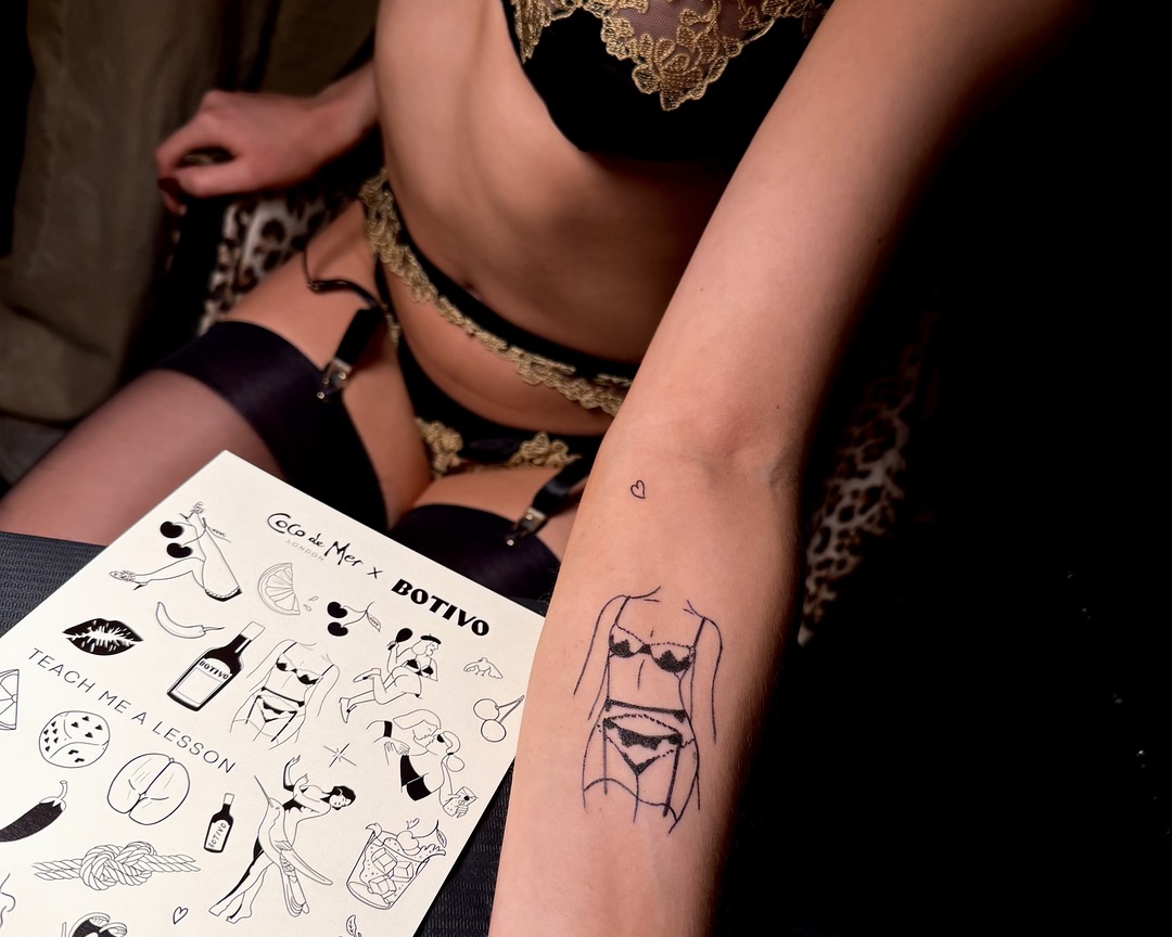 Guest with a fine line lingerie figure forearm tattoo by Matt Roe