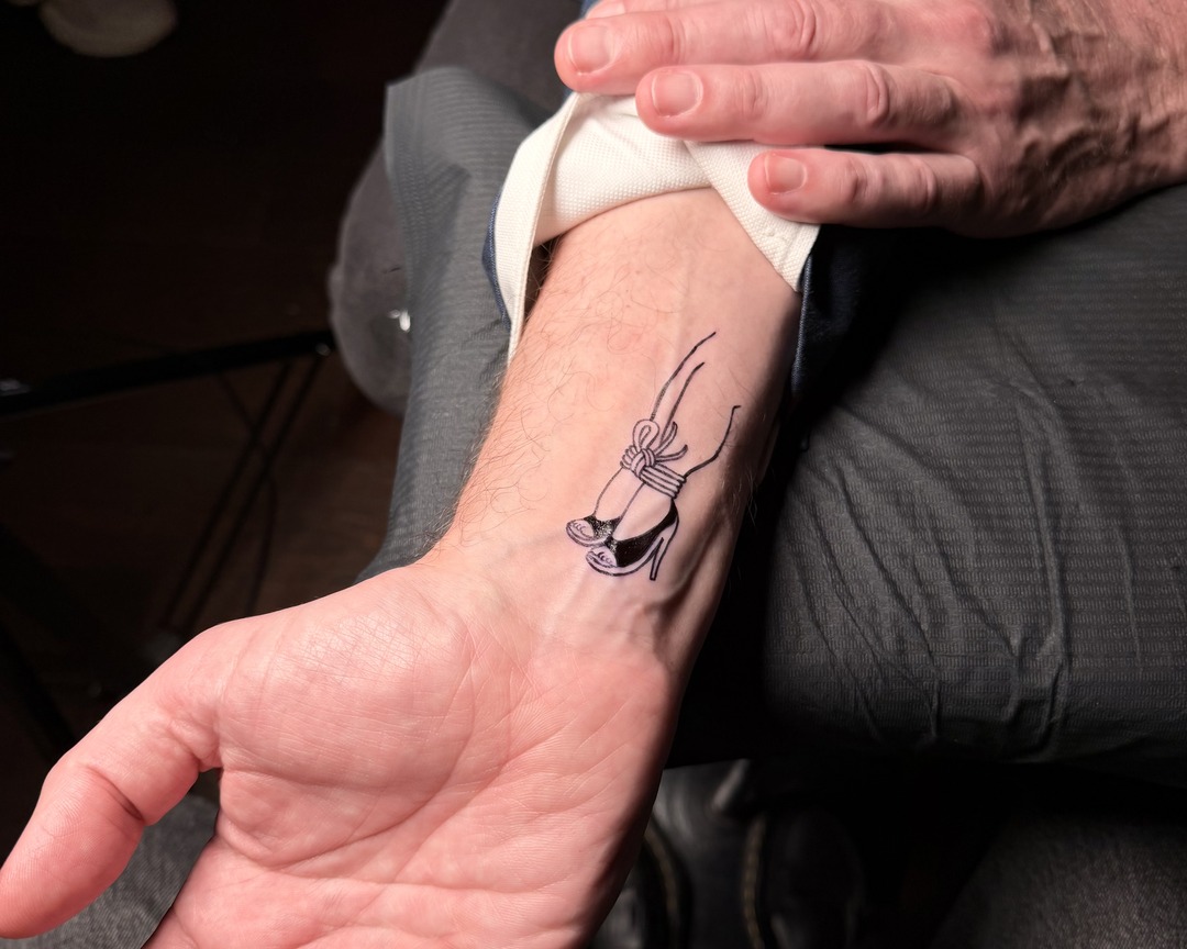 Fine line high heel wrist tattoo by Matt Roe