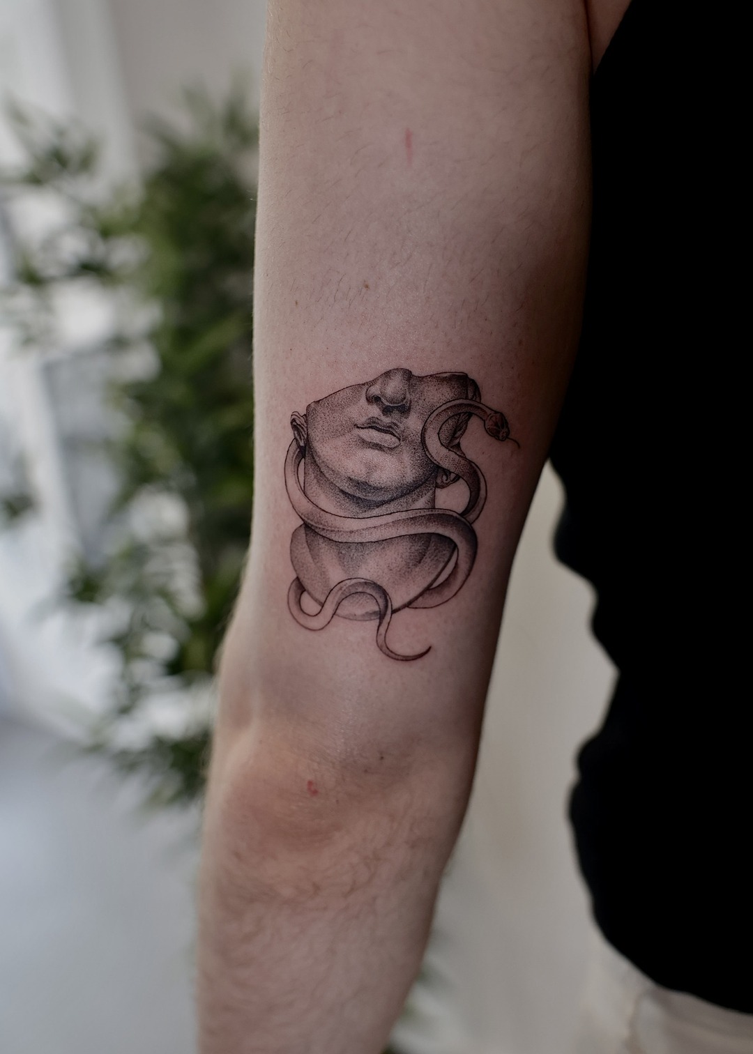 Medusa goddess bust with snake upper arm tattoo, fine line by Matt Roe, Kensington London
