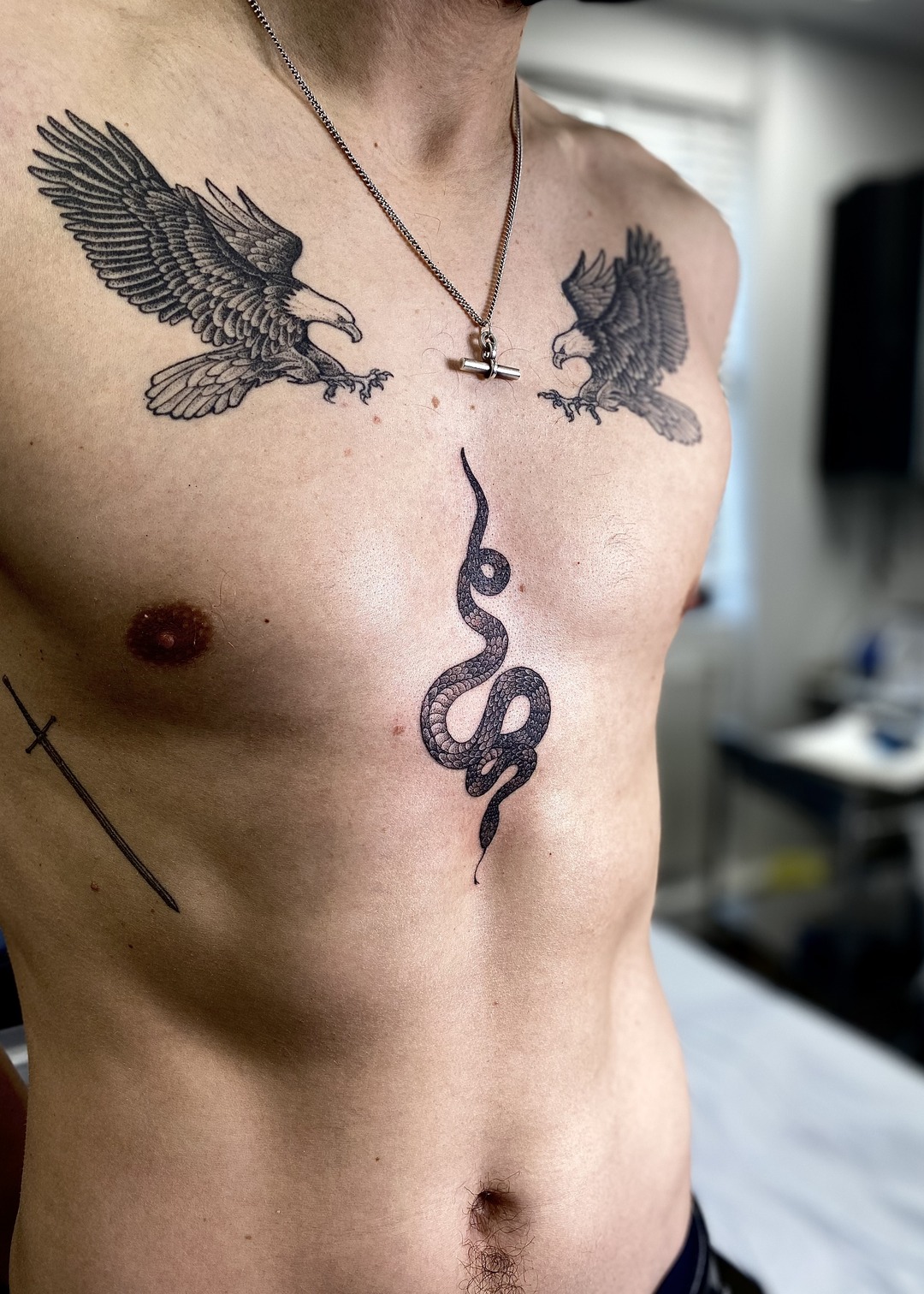 Patchwork eagles and snake chest tattoo, black and grey by Matt Roe, Kensington London