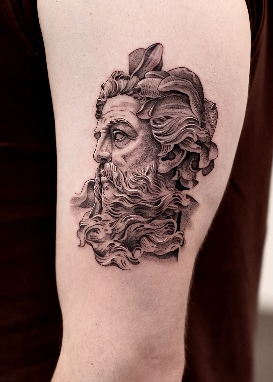 Poseidon bust portrait upper arm tattoo, black and grey by Matt Roe, Kensington London
