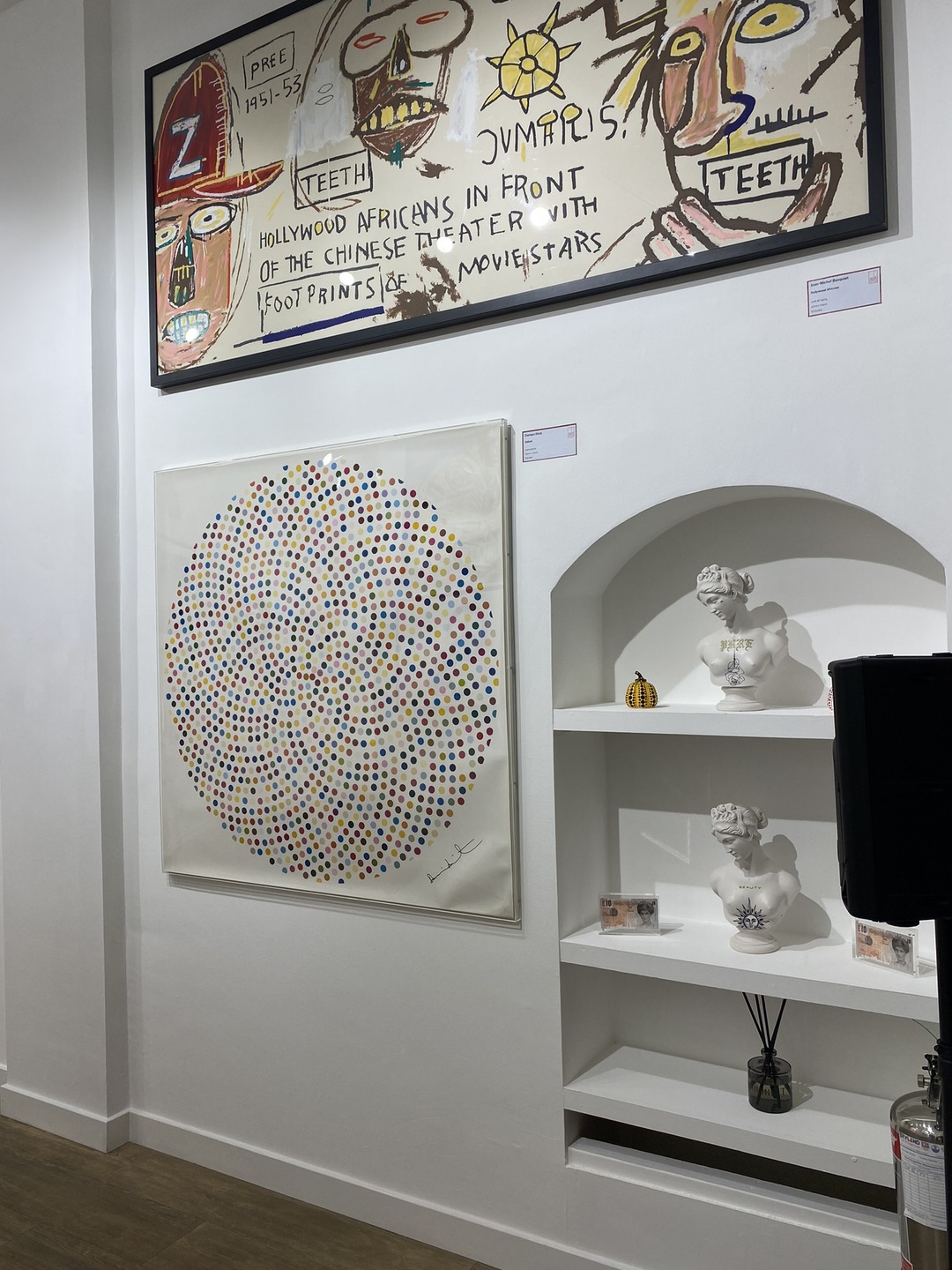 Matt Roe busts in an alcove beside Hirst and Basquiat works at Red Eight Gallery