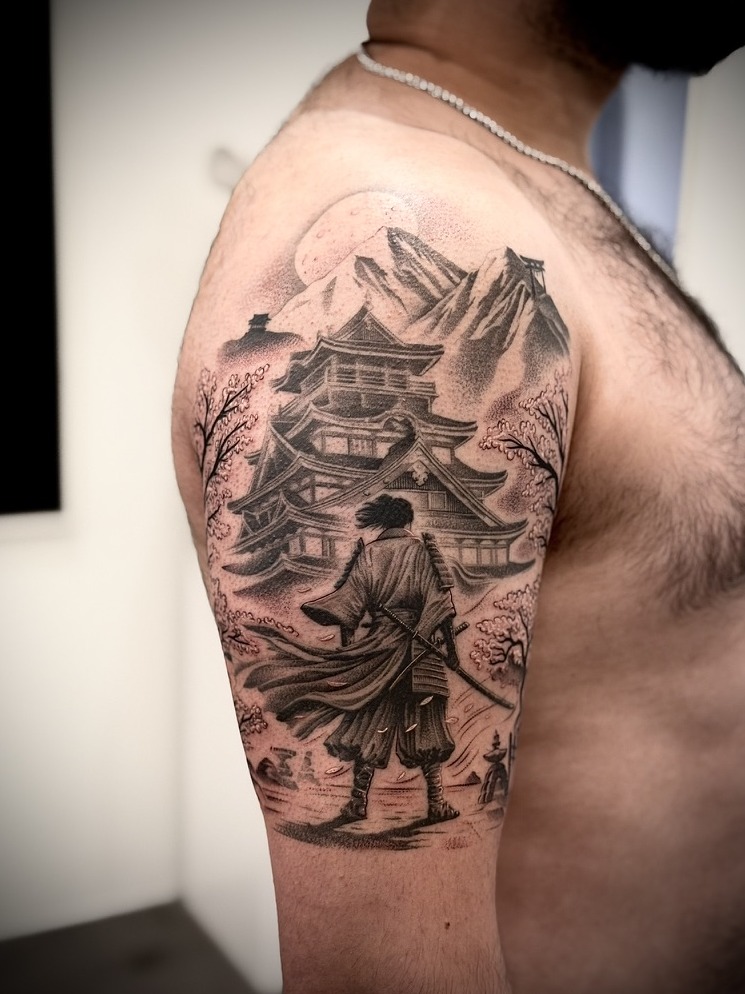 Samurai before a castle with cherry blossom and moon, upper arm tattoo, black and grey by Matt Roe, Kensington London