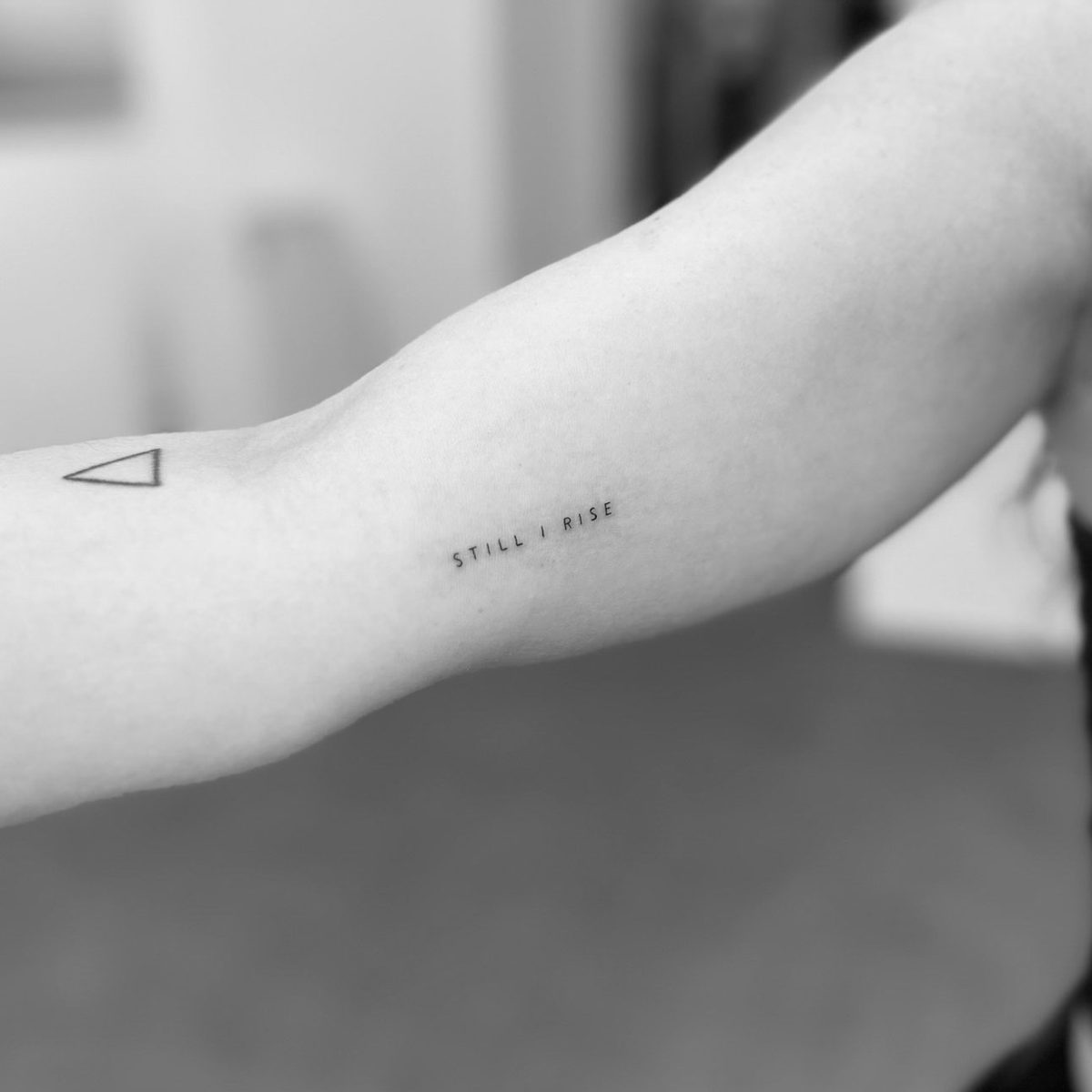 Fine line text and triangle tattoo on arm by Matt Roe, London