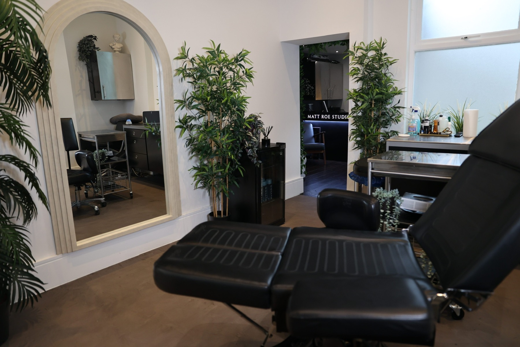 Private tattoo room with arched mirror and Matt Roe Studio entrance, Kensington London
